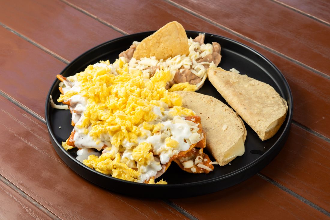 A breakfast plate with eggs and tortillas