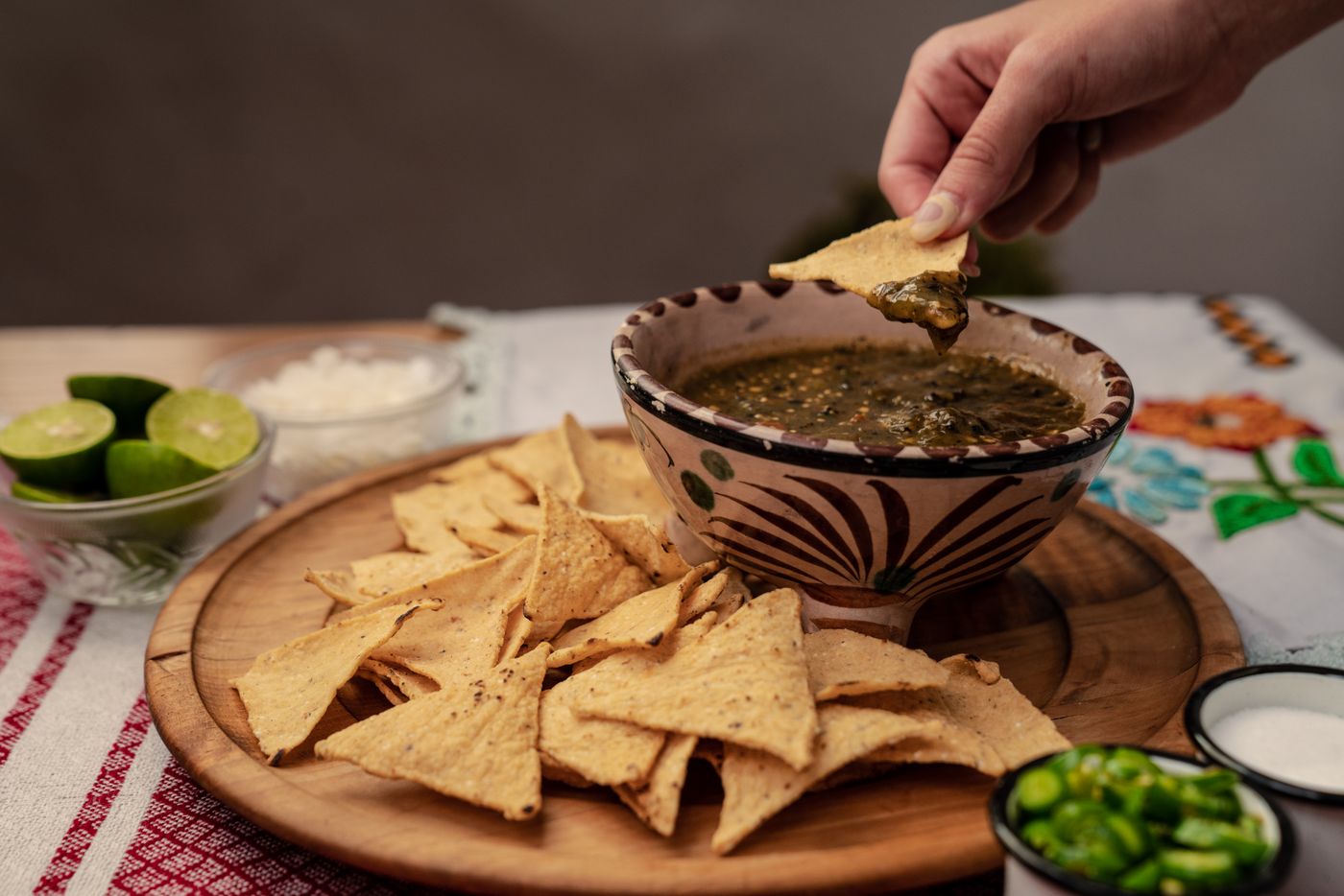Tortilla chips and a bowl of green salsa