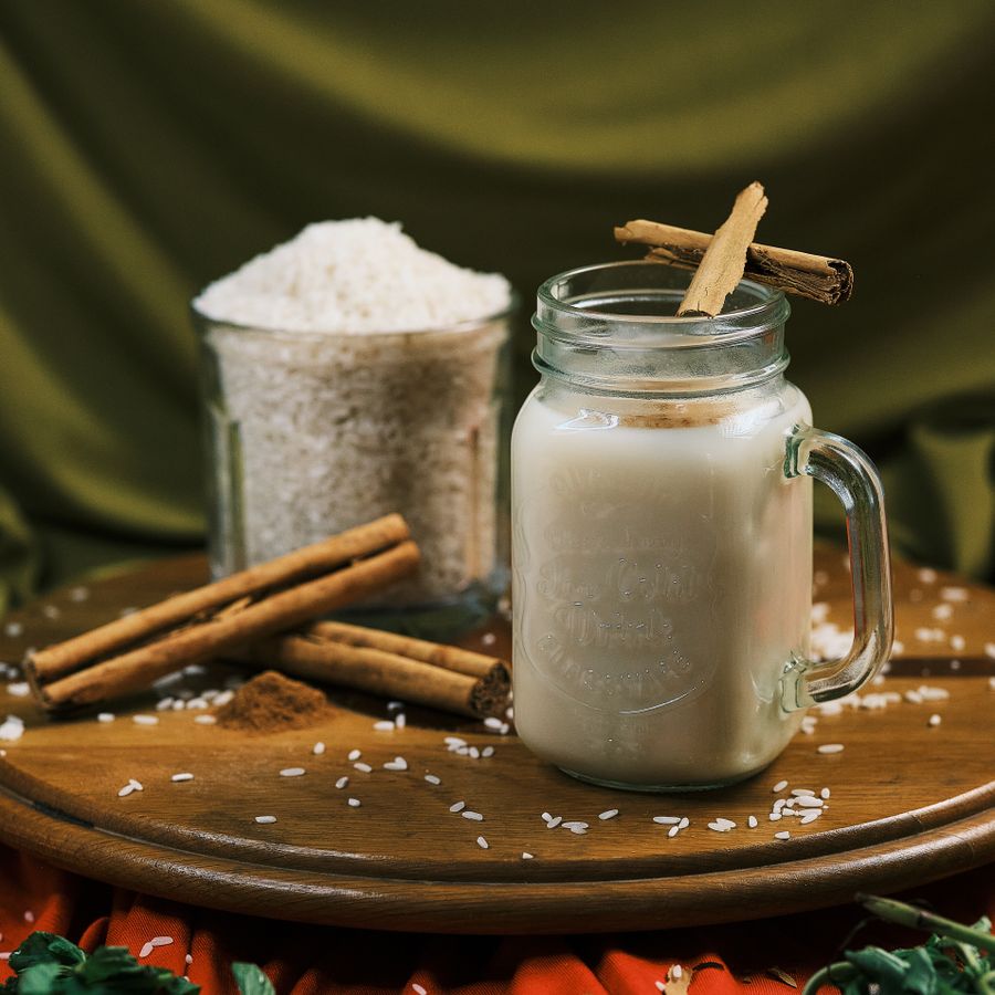 A glass of horchata with cinnamon sticks